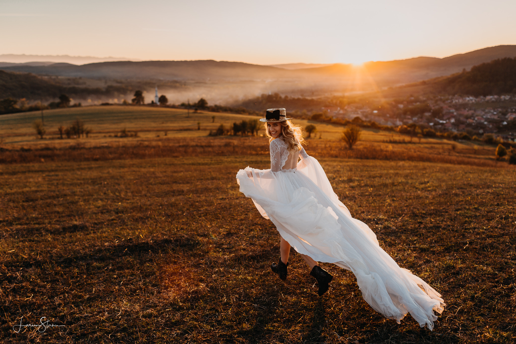 bride running on the fields in the sweet light of the golden hour, dressed in a silk wedding dress